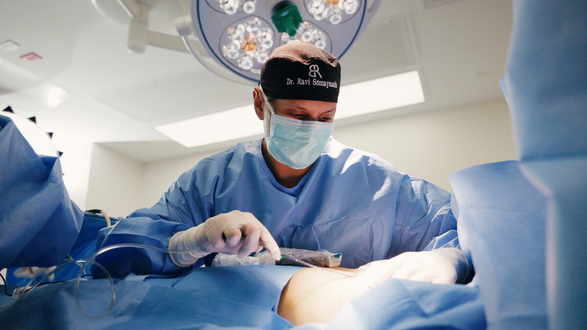 Plastic surgeon performing a procedure in the operating room for a long-form patient education video library