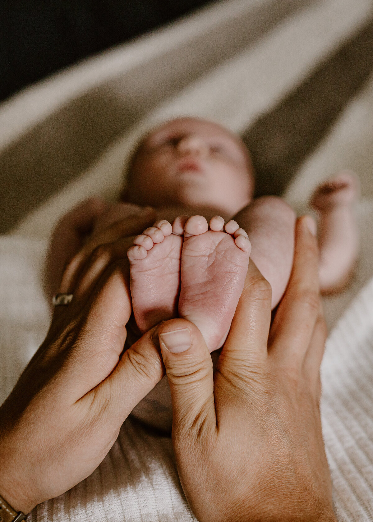 Mom holding newborn feet