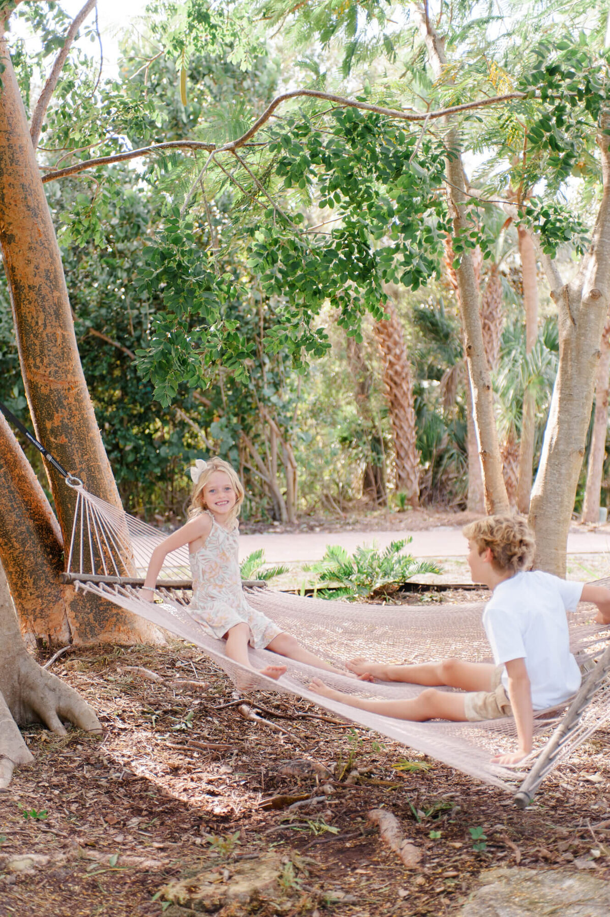 Kids playing in a hammock during their family photography session in Orlando, Florida.