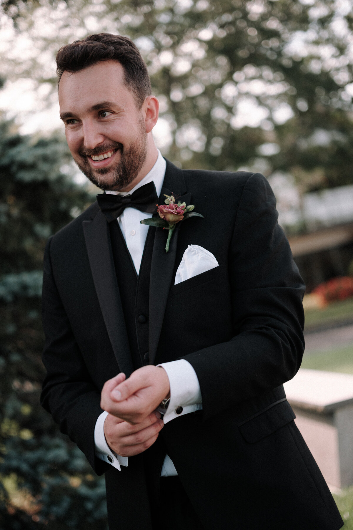 groom gets ready outside at his wedding
