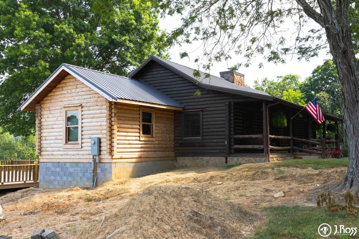 professional painting contractor staining log home in johnson city