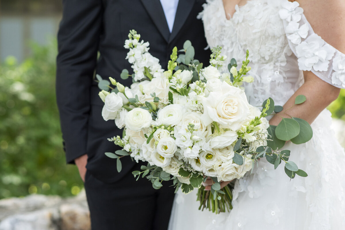 couple holding wedding bouquet 