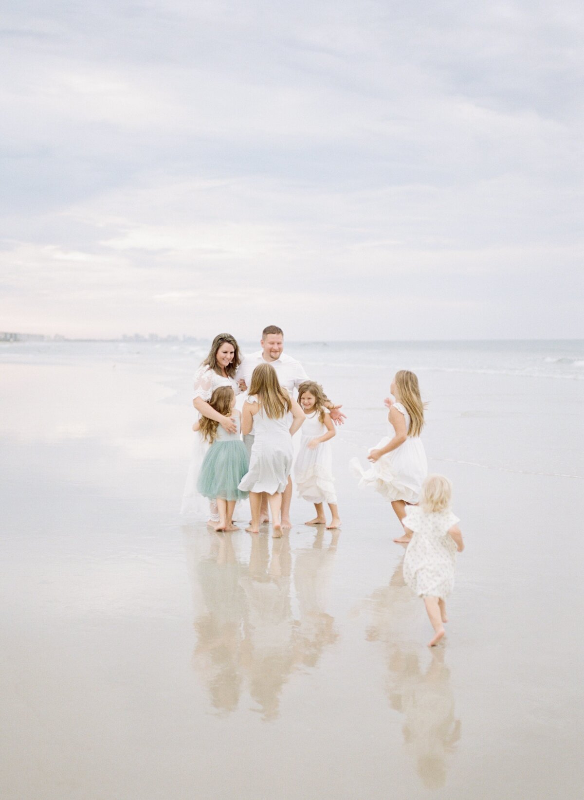 family at the beach with reflection in water by Orlando family photographer