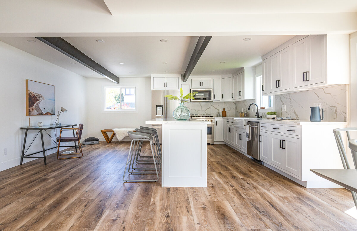 open-layout-kitchen-marble-backsplash-bar-seating
