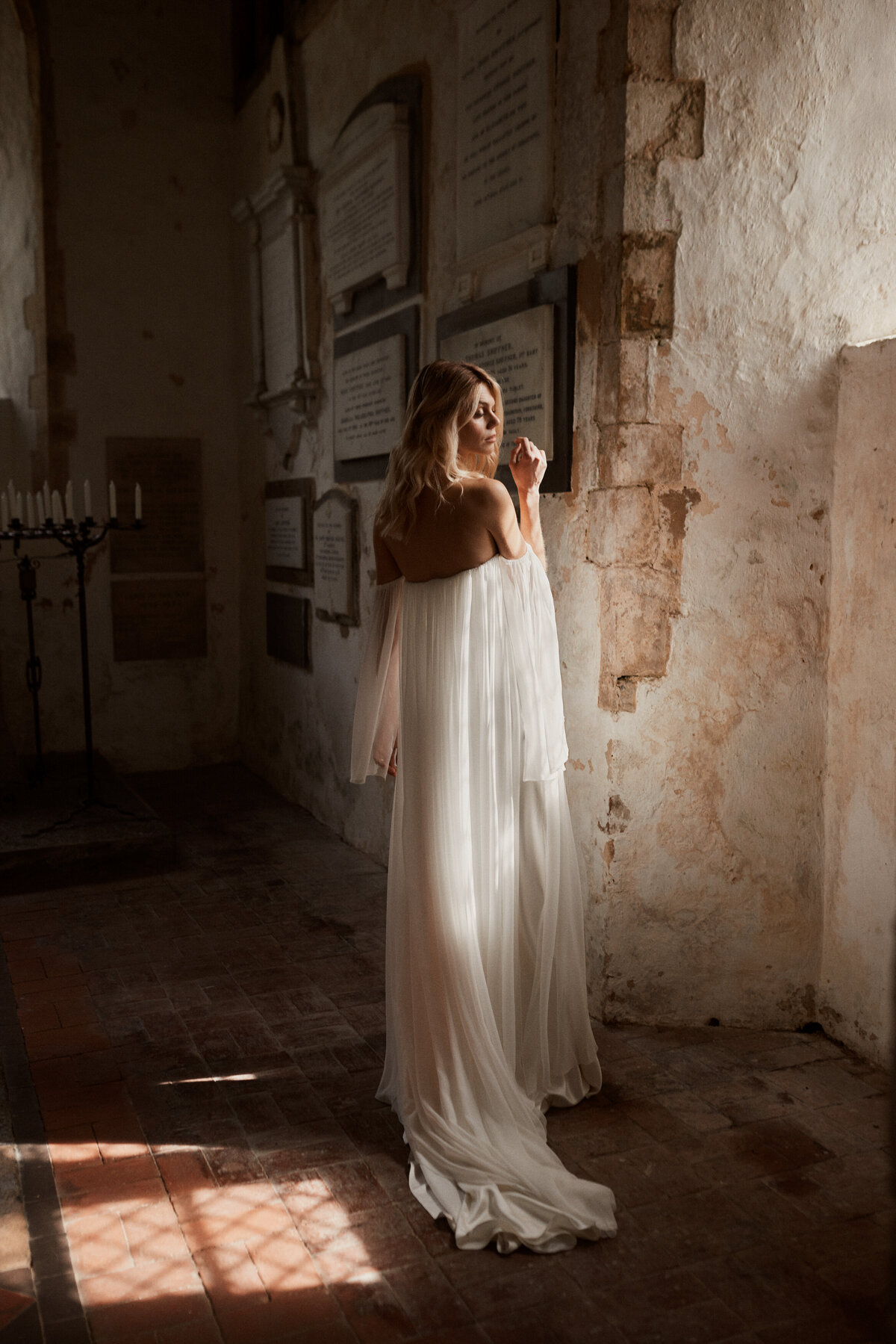 Detachable sleeves silk wedding dress by Luna Bea on bride in church