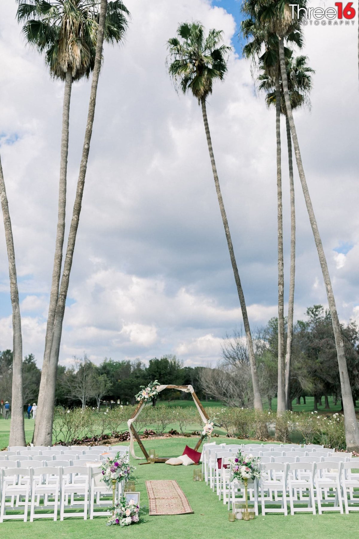 Tall palm trees overlook a Los Coyotes Country Club Wedding Venue ceremony location