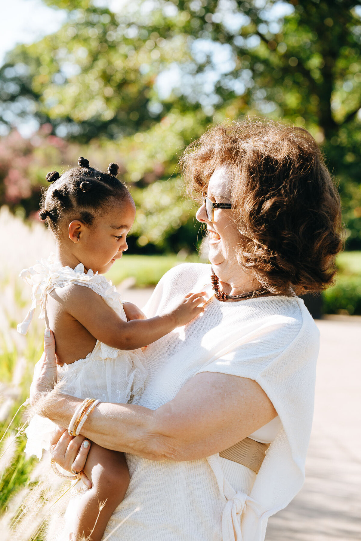 grandma holding granddaughter and smiling