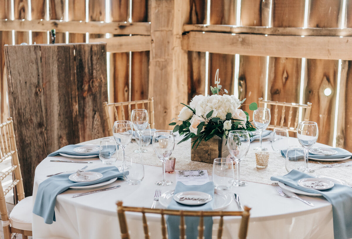 Beautiful barn wedding reception with blue and gold decor