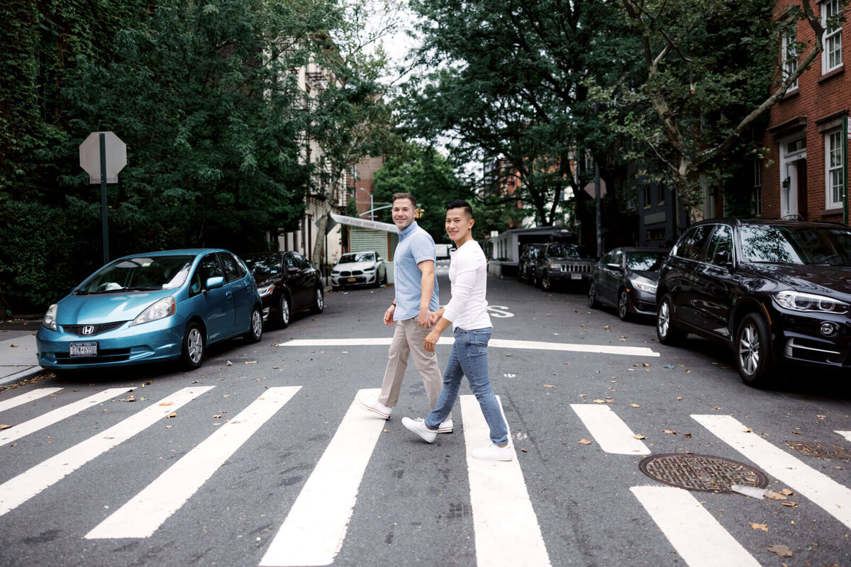 The engaged couple is happily crossing the street while holding hands in West Village, NYC. Image by Jenny Fu Studio