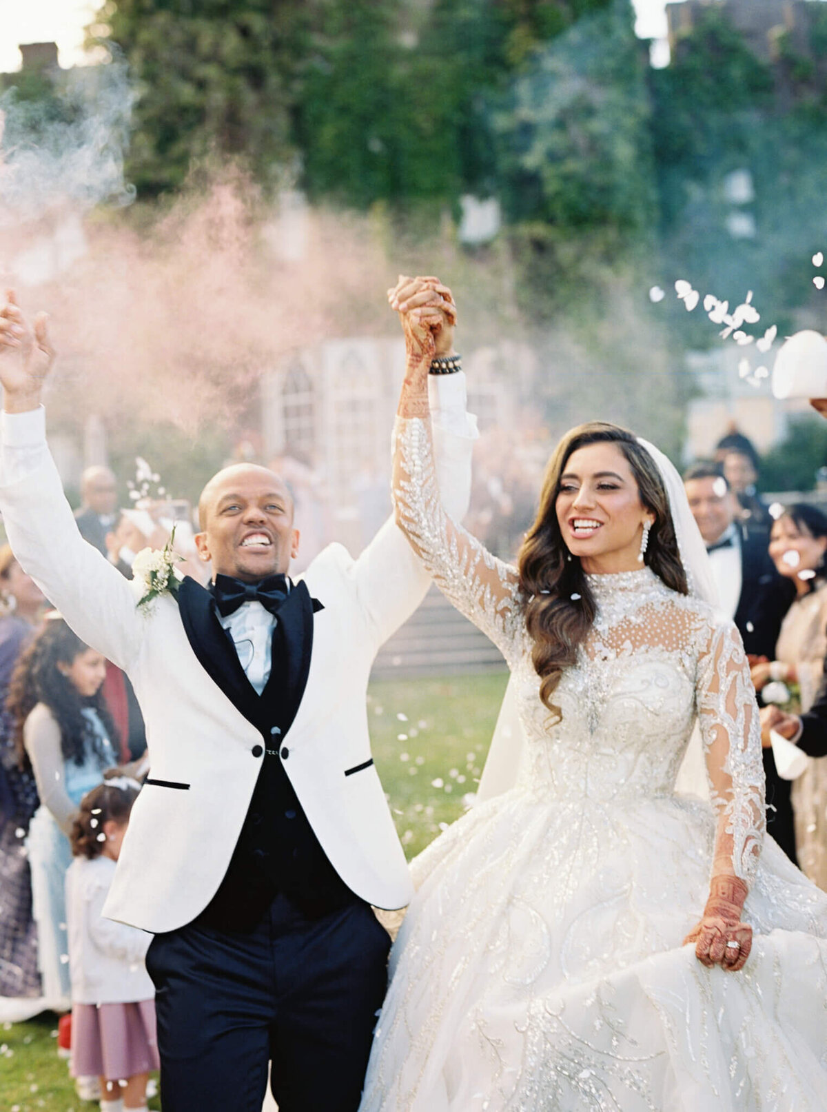 A wedding photo of a couple celebrating their marriage with their friends surronding them at Luttrellstown Castle in Ireland