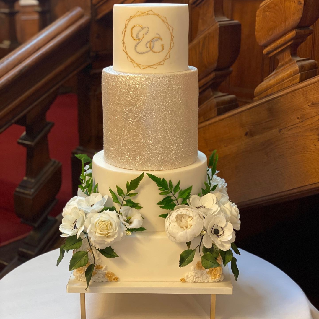 4 tier wedding cake with monogram, glitter and sugar flowers