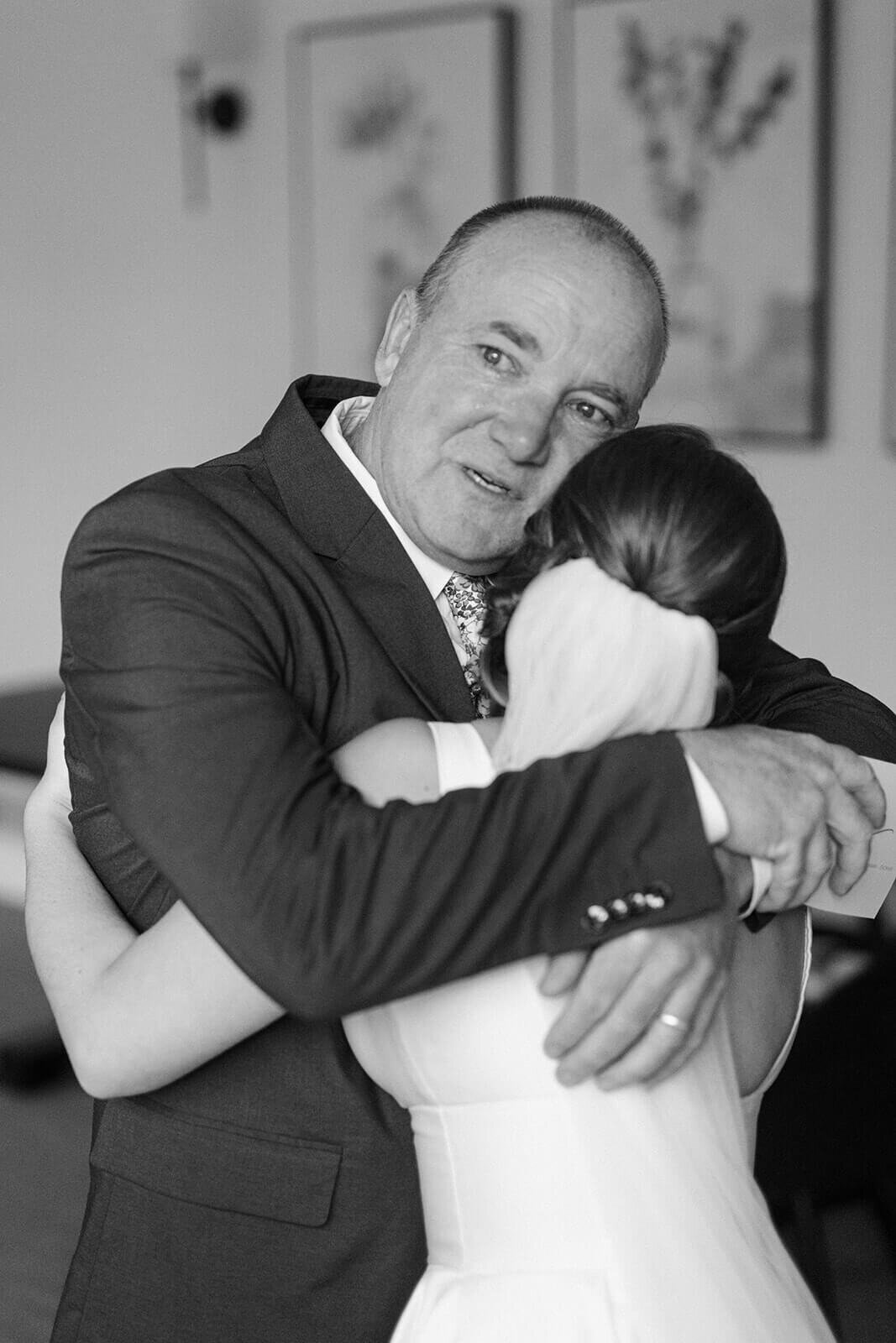 Bride hugging father before wedding in Oswego NY