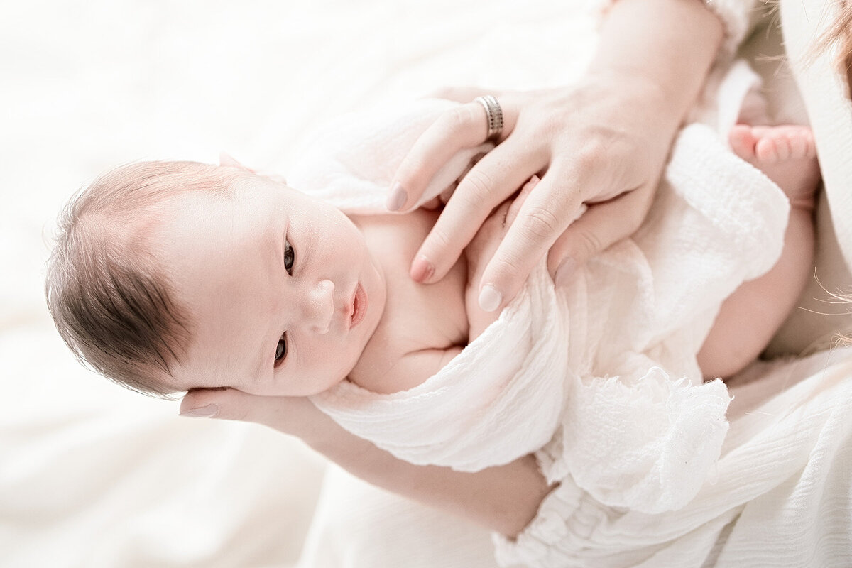 newborn baby looking at camera