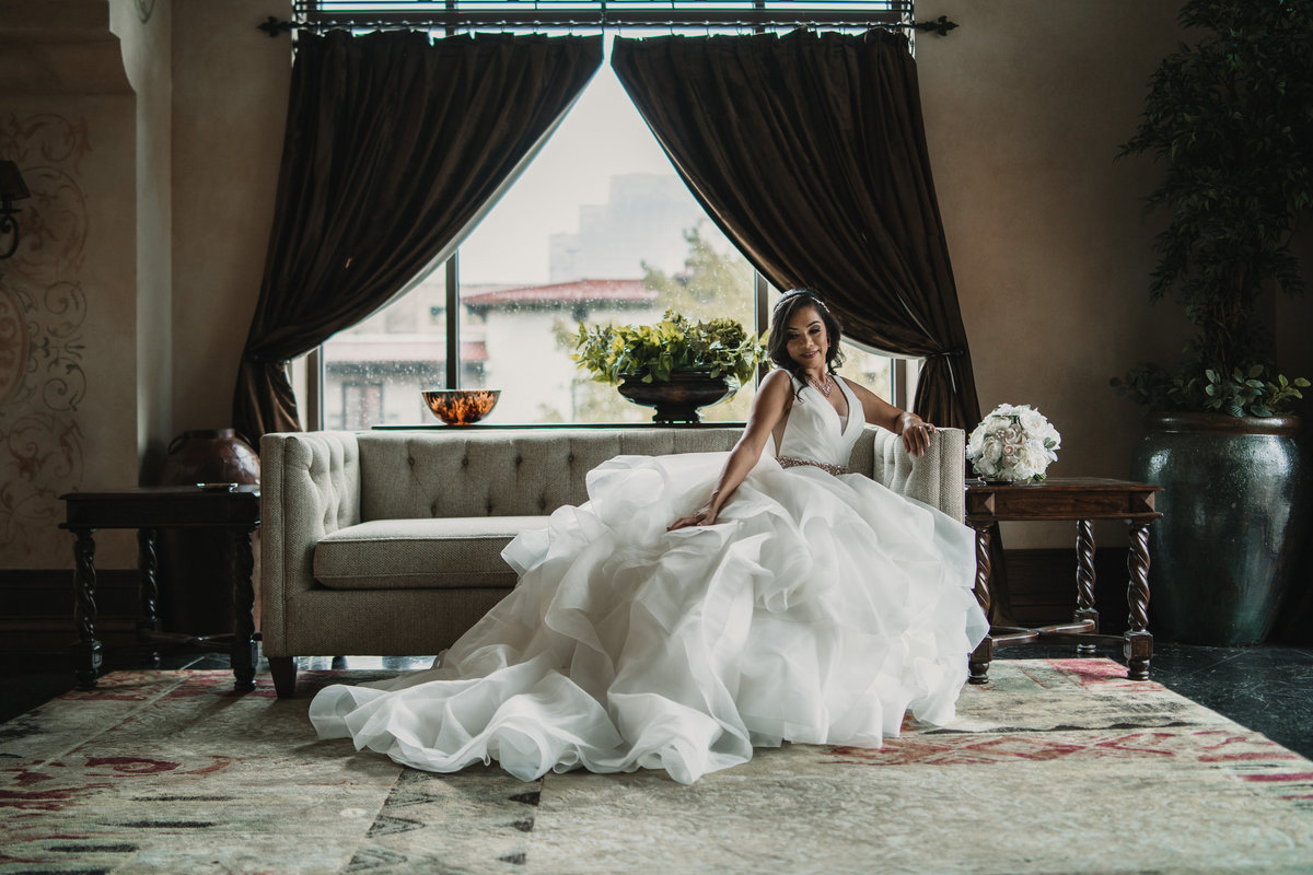 Bride sitting on couch posing for her bridal picture taken by San Antonio wedding photographer Expose The Heart