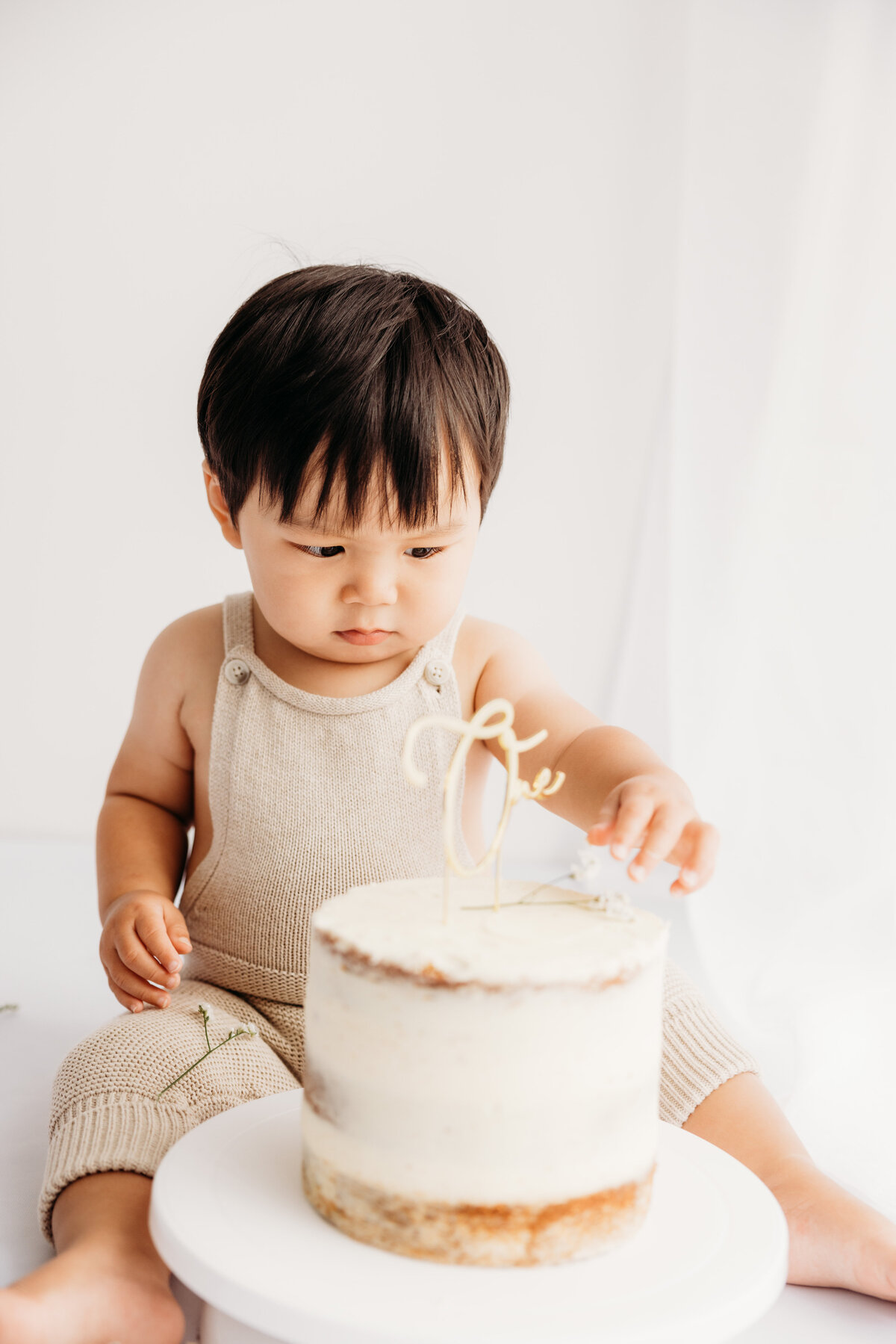 Baby hudson with her first birthday cake during his cakesmash photoshoot