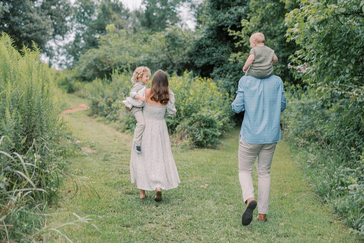 family-of-four-walking-in-meadow
