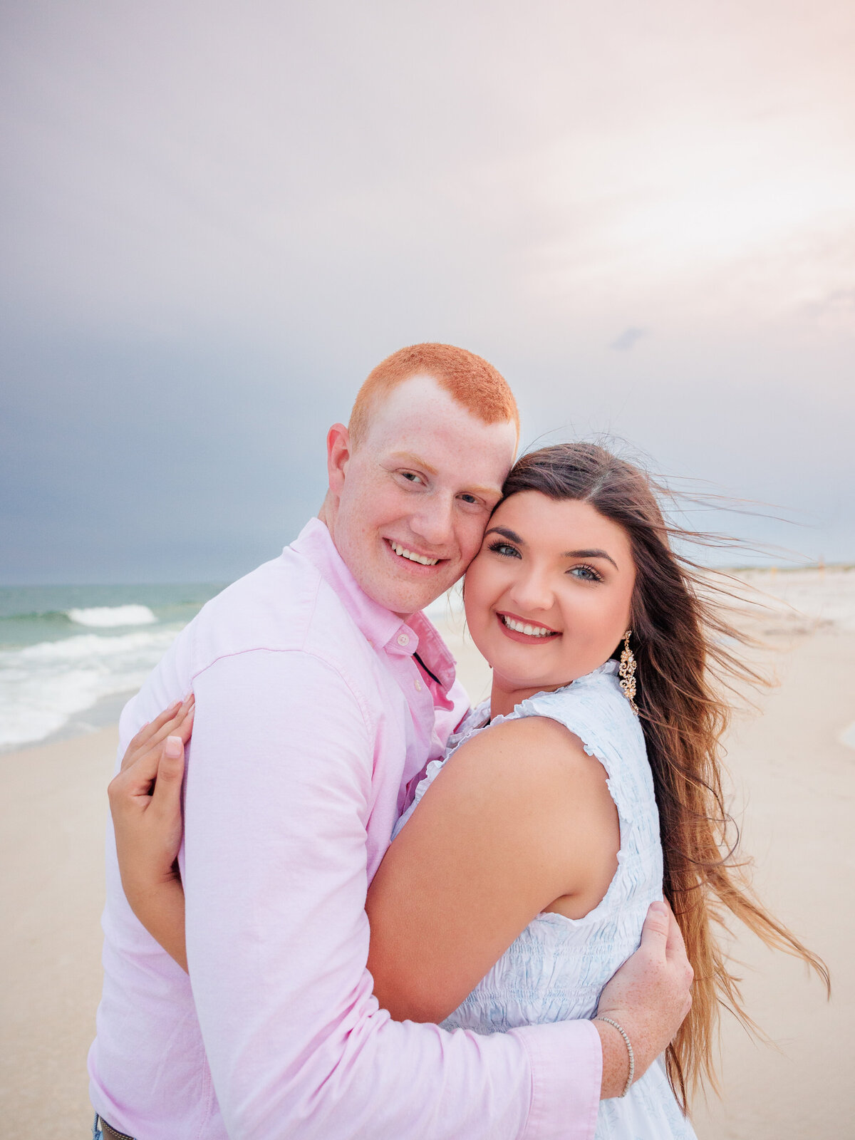 Close-up of intertwined as a young couple with hair blowing in the wind 