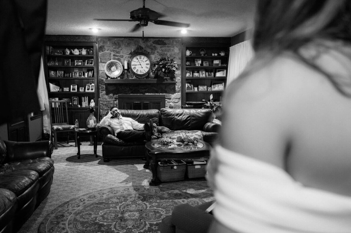 groom-watching-bride-in-living-room