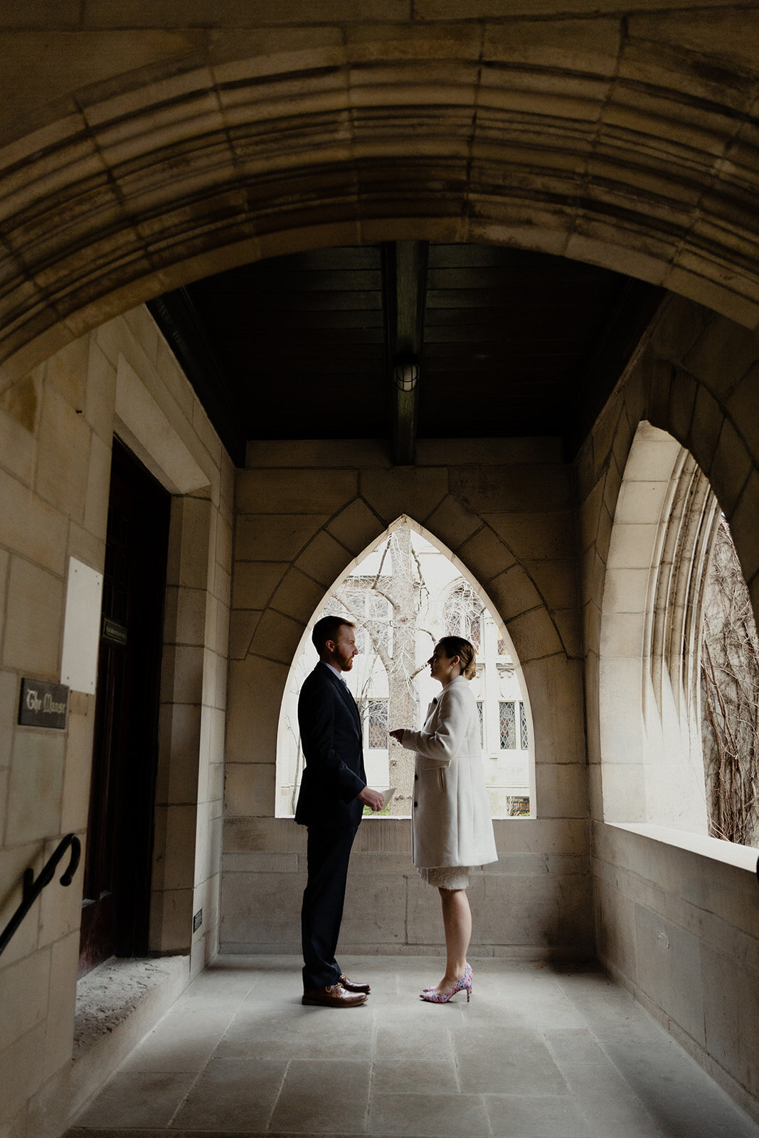 Just Married photo session couple in an old Chicago church couple in cloister reads their personal vows to each other