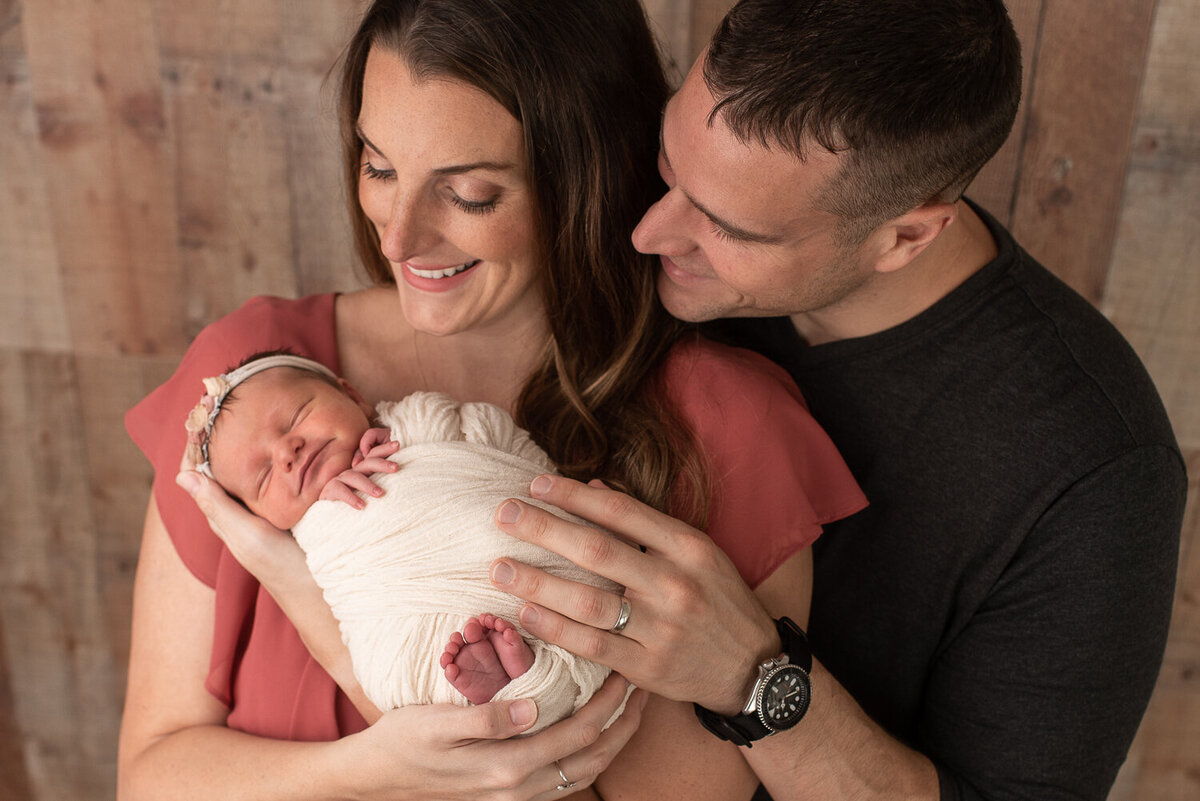 Mom and dad smiling at baby girl in mom's arms at newborn session |Sharon Leger Photography || Canton, CT || Family & Newborn Photographer