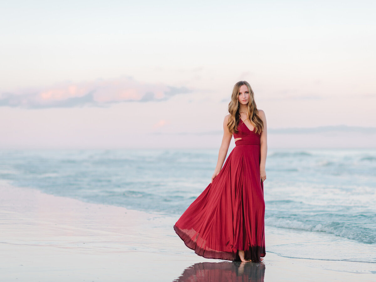girl in red dress; Vibrant Senior Photoshoot at the Beach in Myrtle Beach