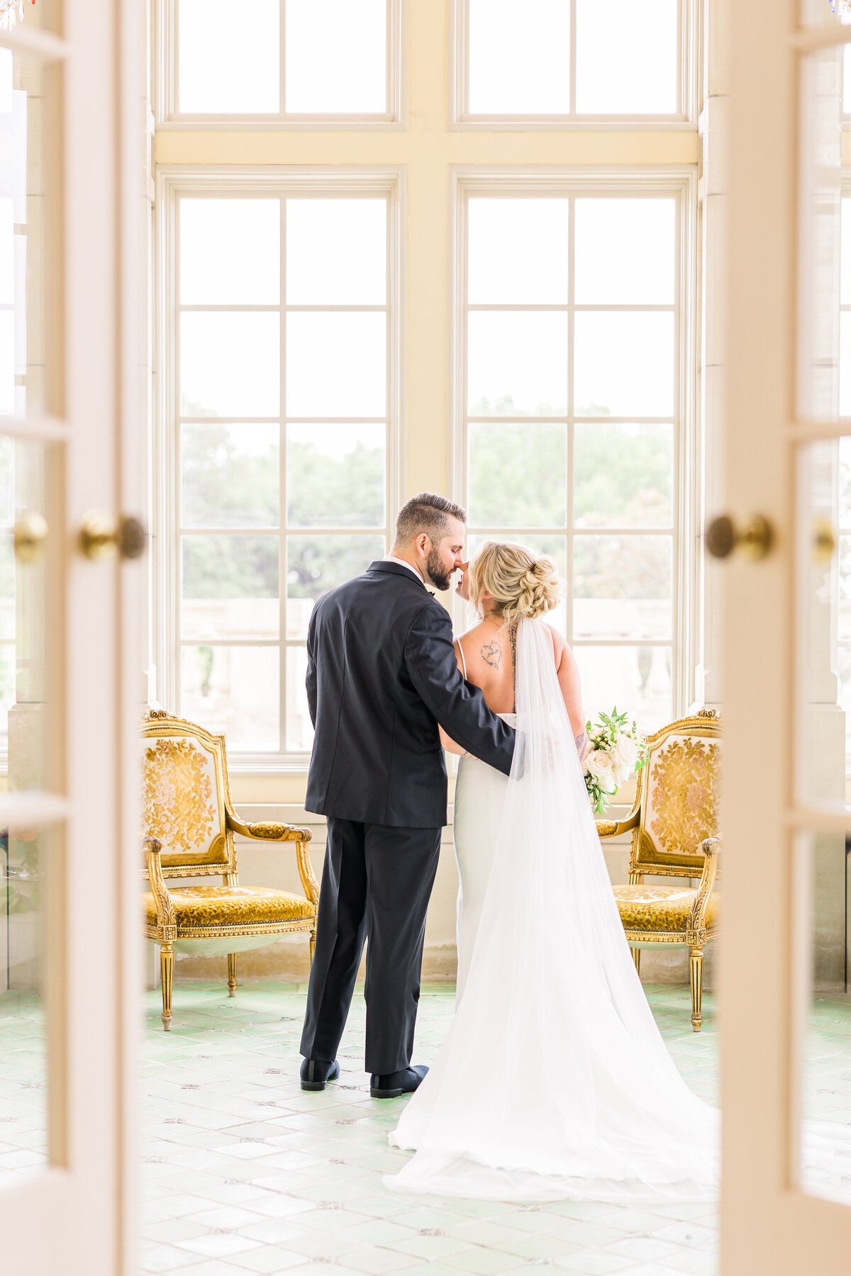 bride-and-groom-sharing-kiss-in-the-gorgeous-tea-room-mansion