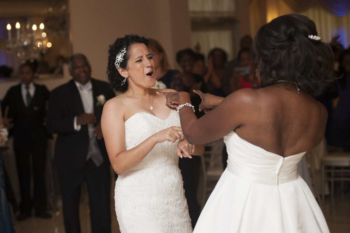 Newlyweds dancing and singing together at their wedding reception 