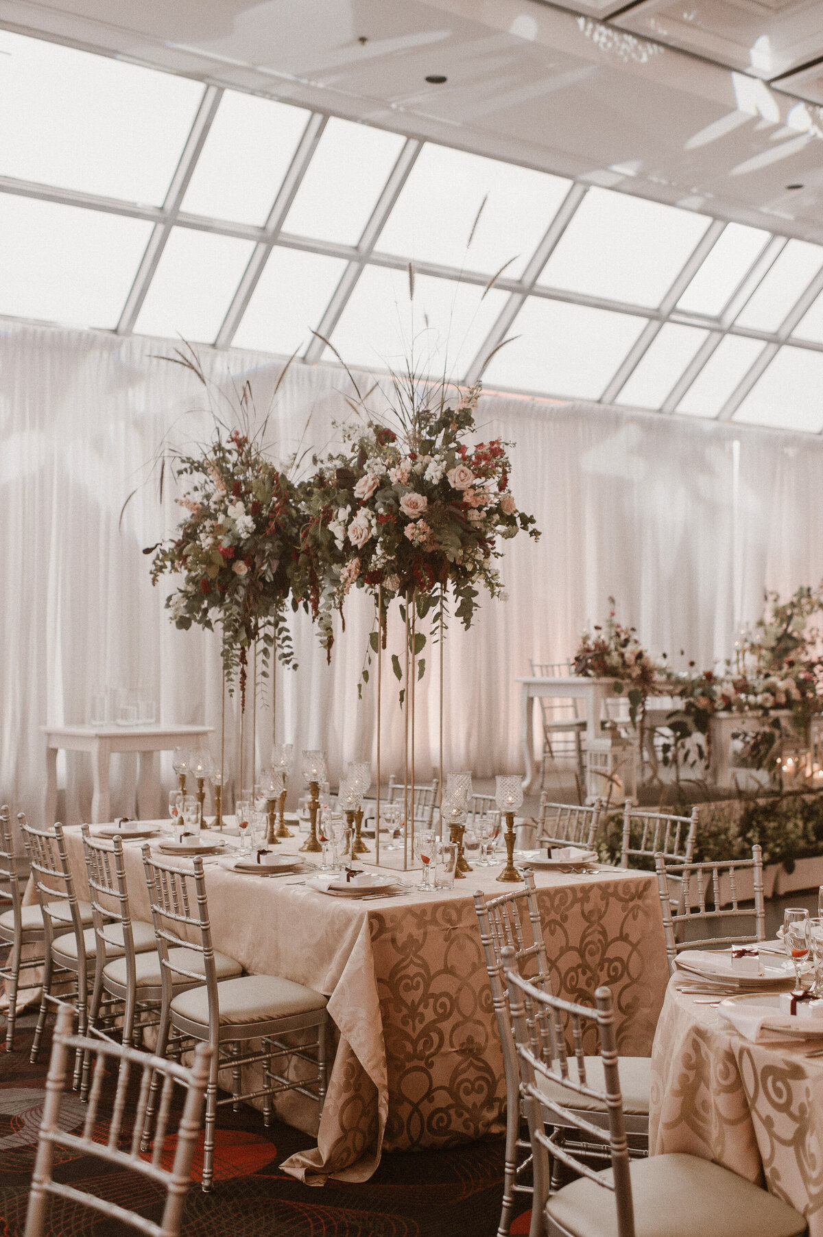 Organic, rustic centrepieces are suspended over a table at a wedding reception in Montreal.