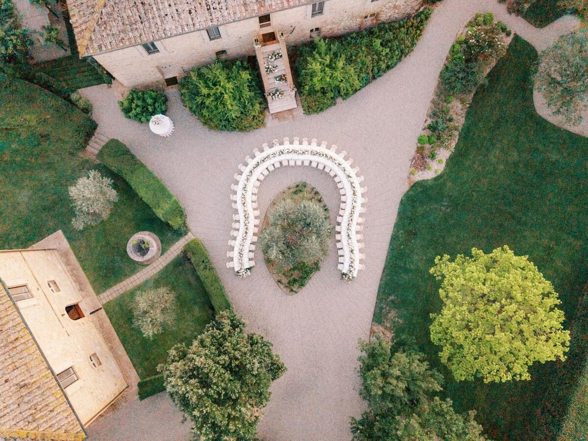 Ombroneta Wedding Ceremony in Tuscany - u-shaped curved dinner seating, symmetrical design as seen from above