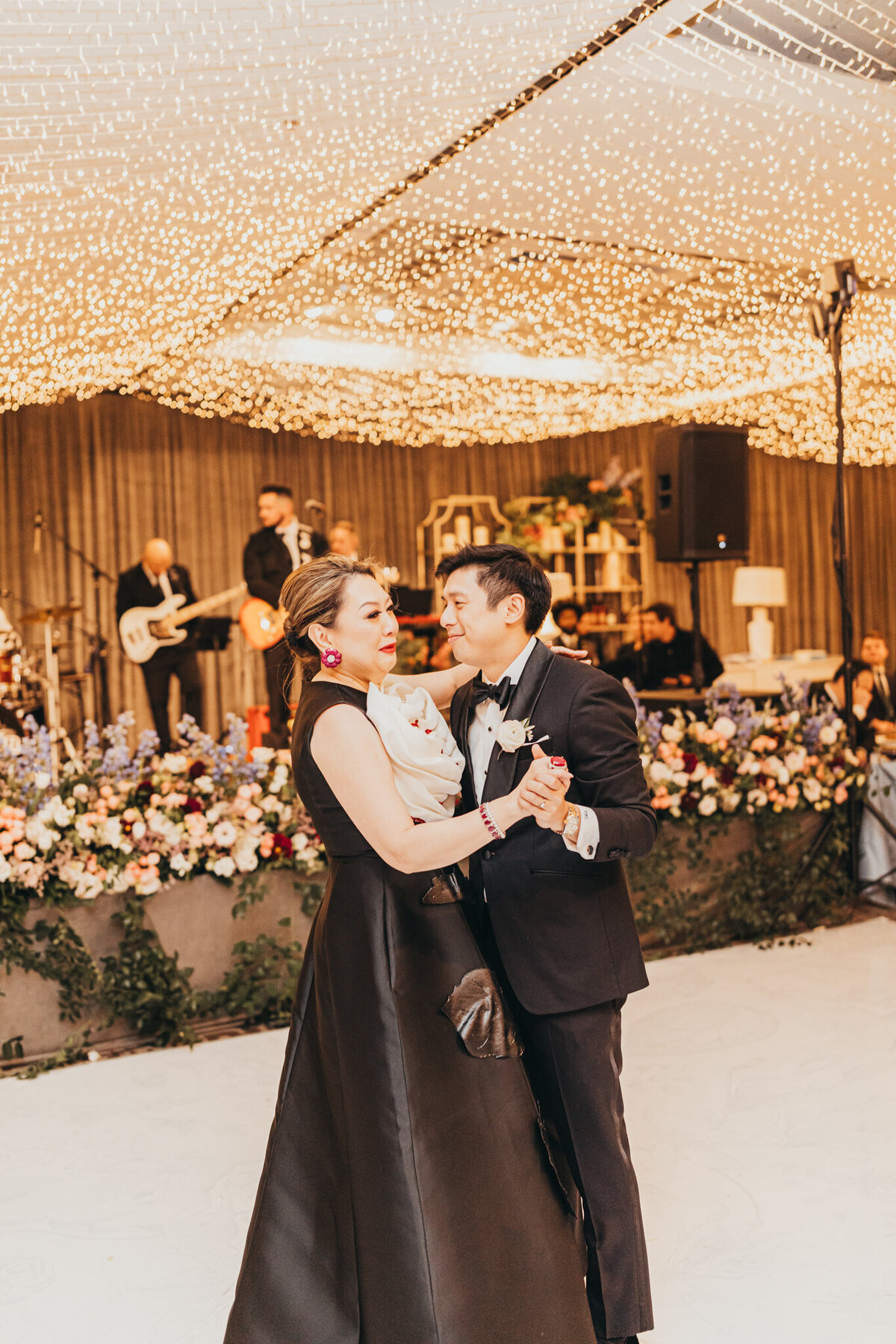 groom and mom share their first dance of the night together