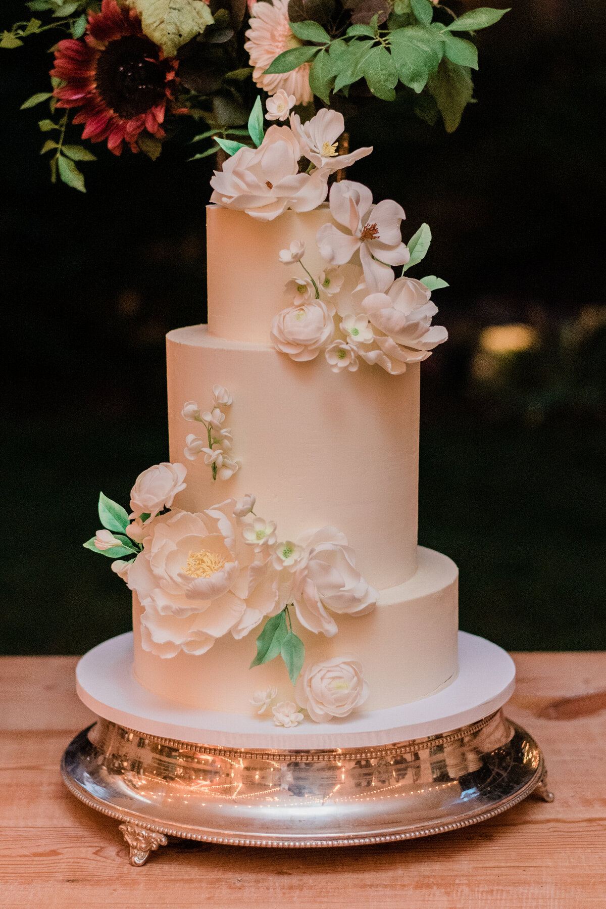 Tall and white wedding cake before being cut 