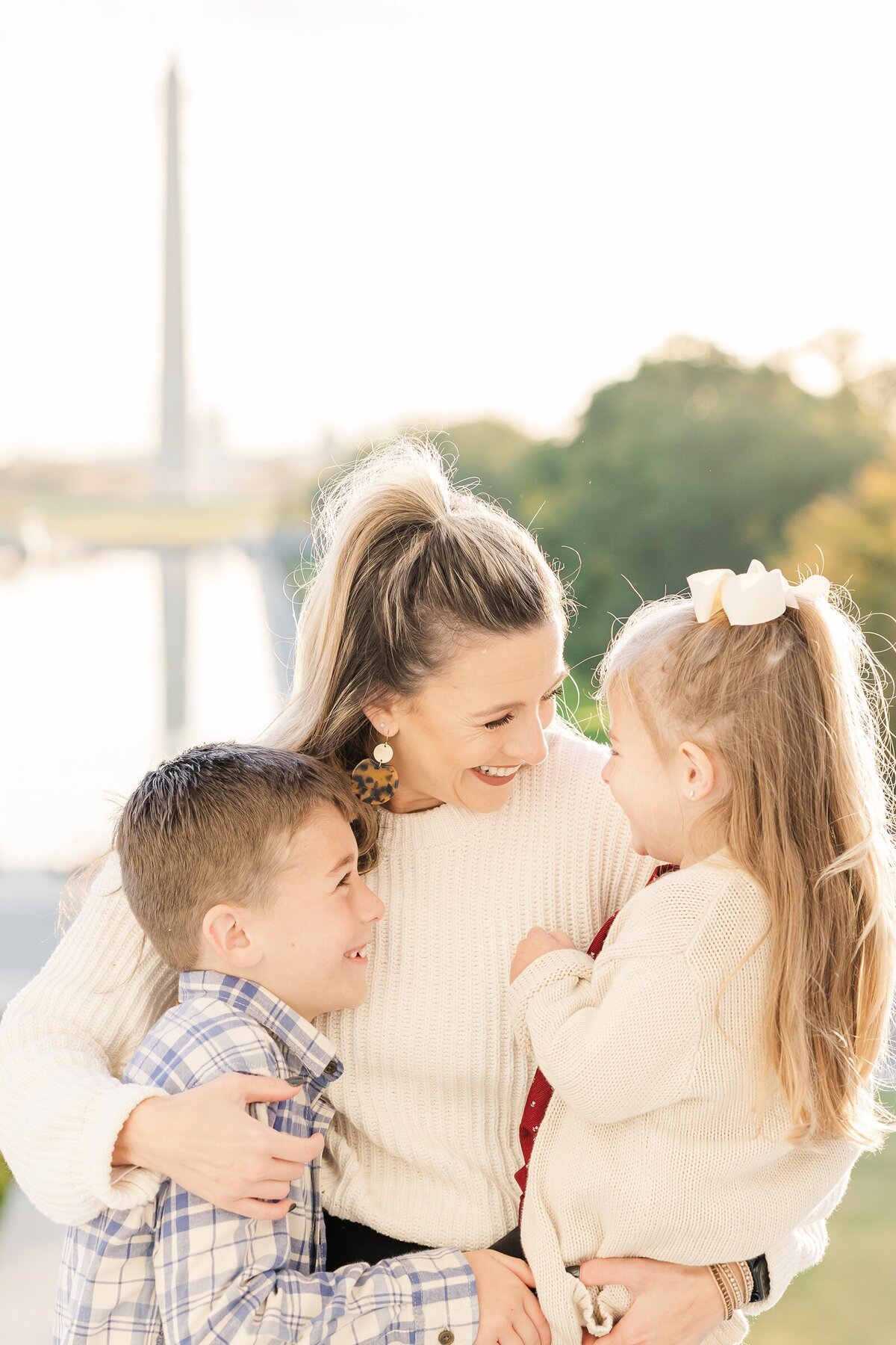Mom laughing with her two small children at Lincoln Memorial family photo session