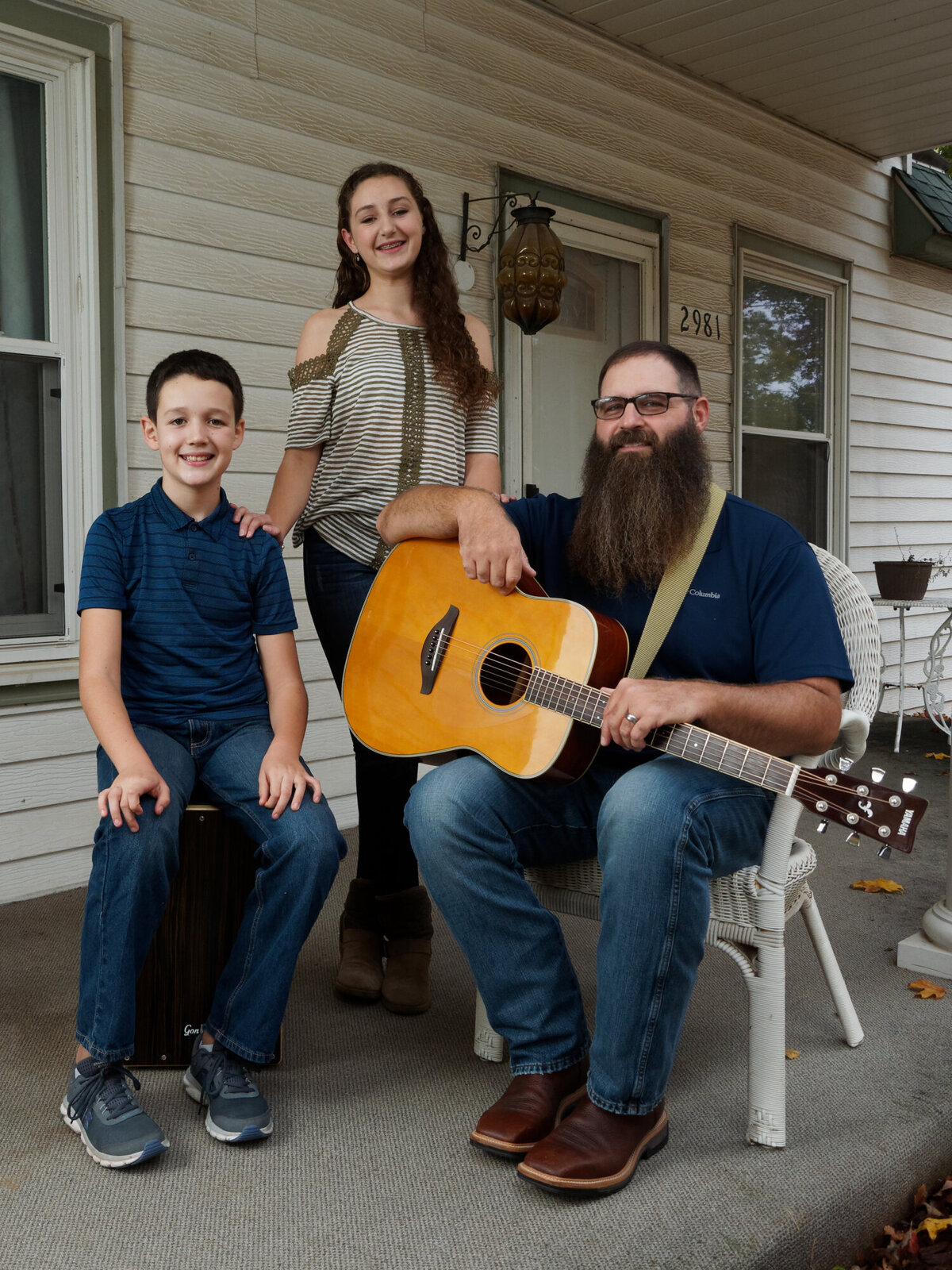 brother sister and dad with guitar outdoor daytime portrait