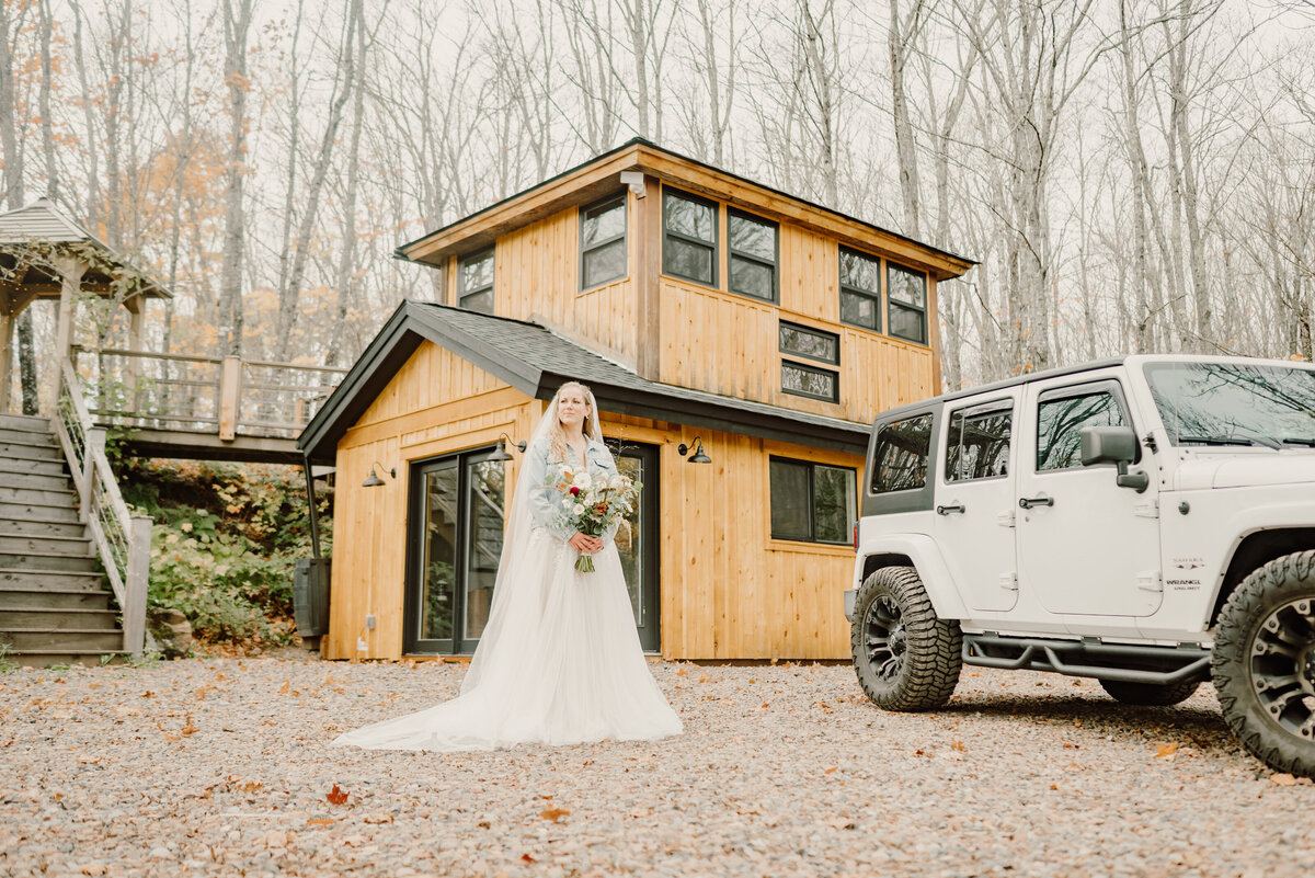 bride with the cabin in the background