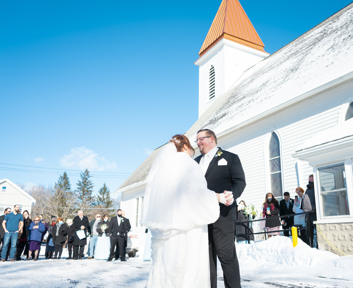 Photo of a bride and groom having their first dance outside