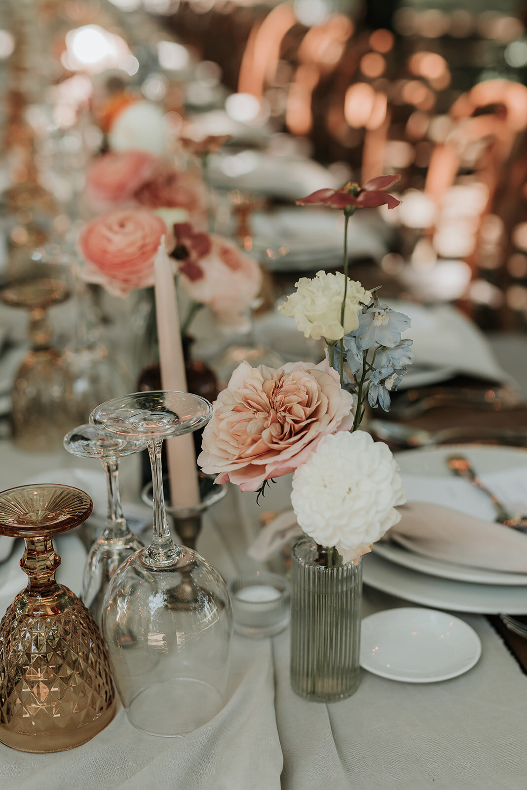 Soft blush and white flowers in a bud vase on a wedding table in Portugal