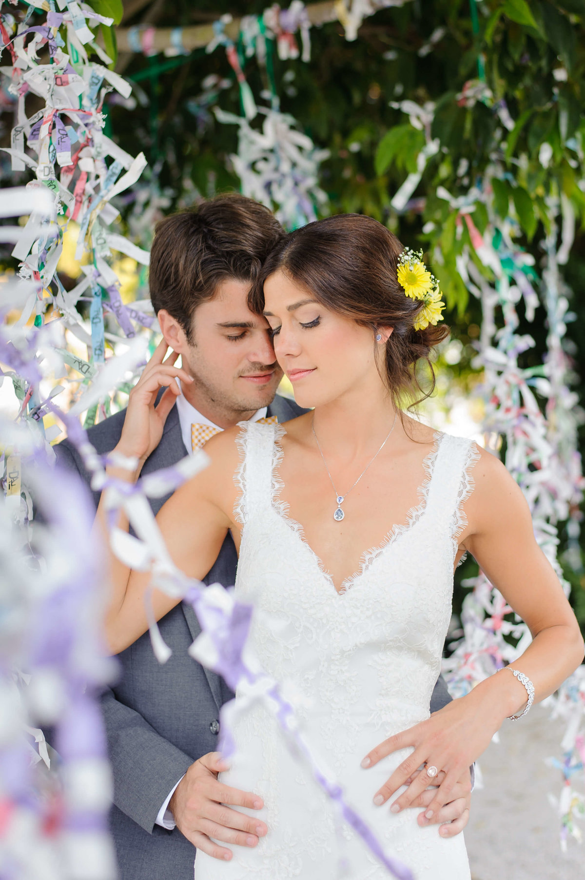 Bride and Groom share a quiet embrace under the tree at the Dali Museum in St. Petersburg, FL