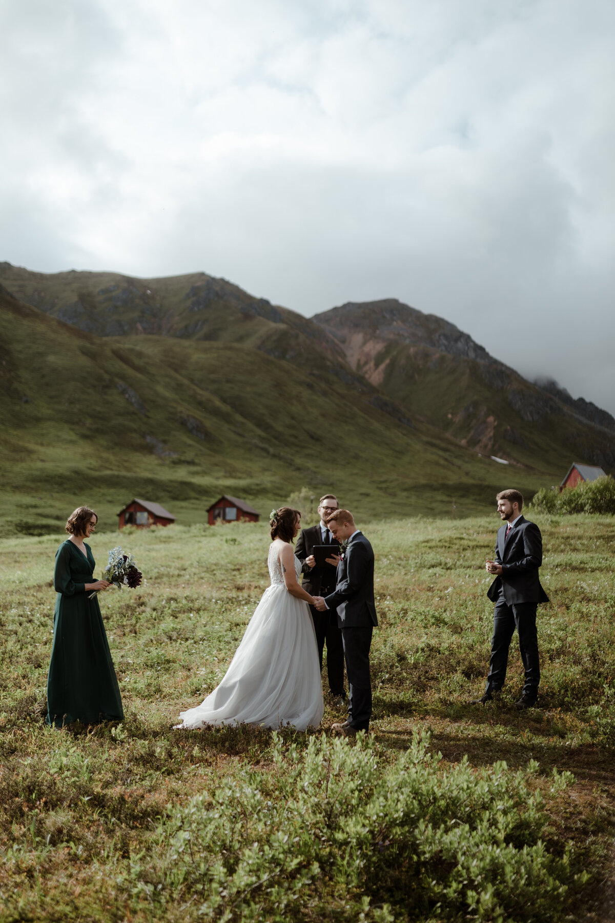 bride and groom standing in field
