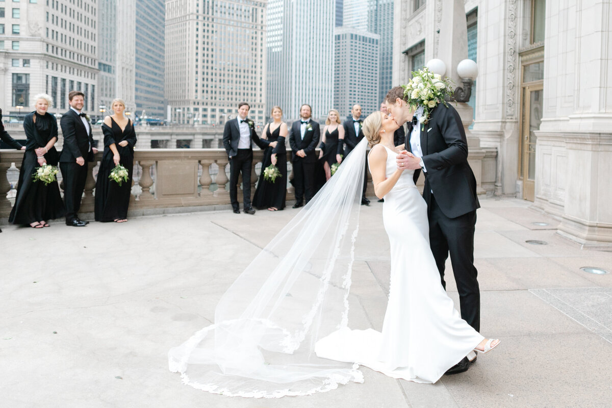 Groom dips bride at the Wrigley building in downtown Chicago on their wedding day