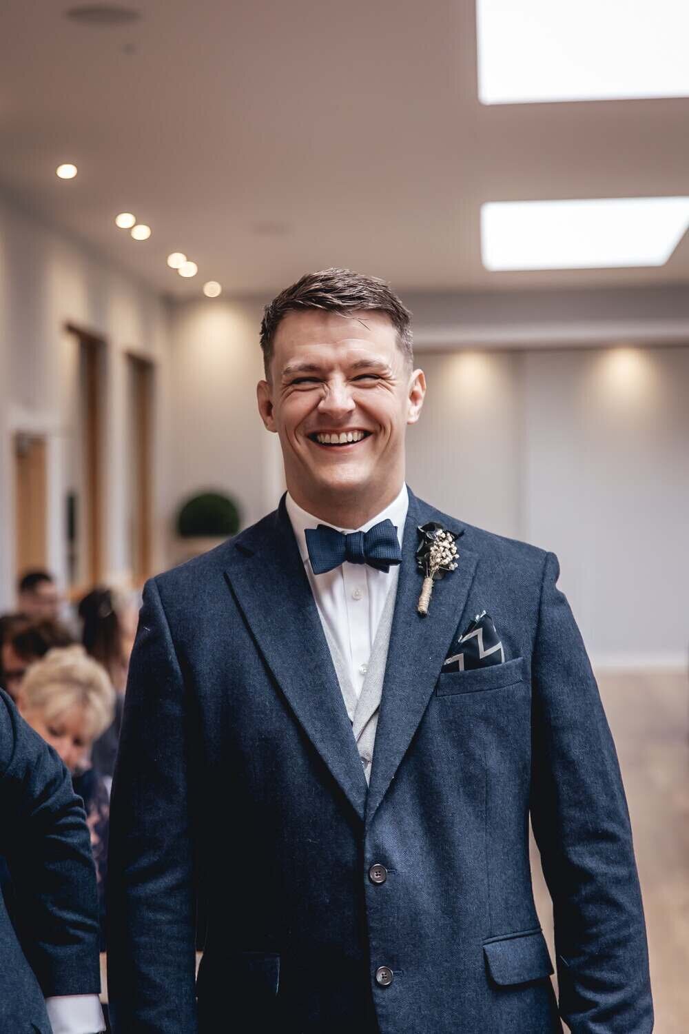 Smiling groom at wedding