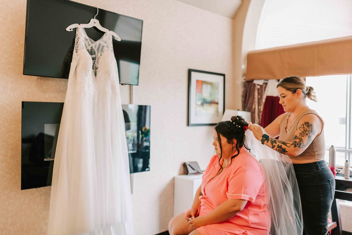 Bride getting her veil pinned on.