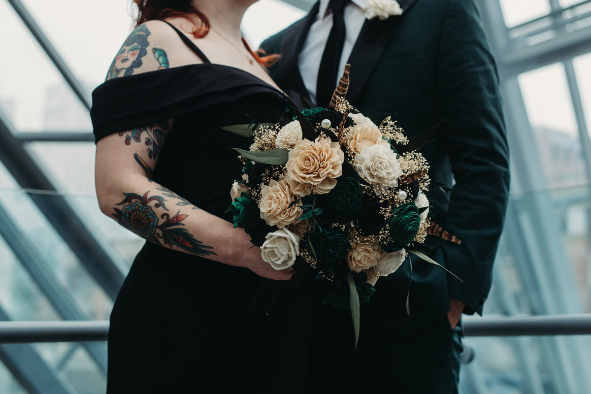 Up close shot of dark green and ivory bouquet for a non-traditional wedding at Akron Musuem