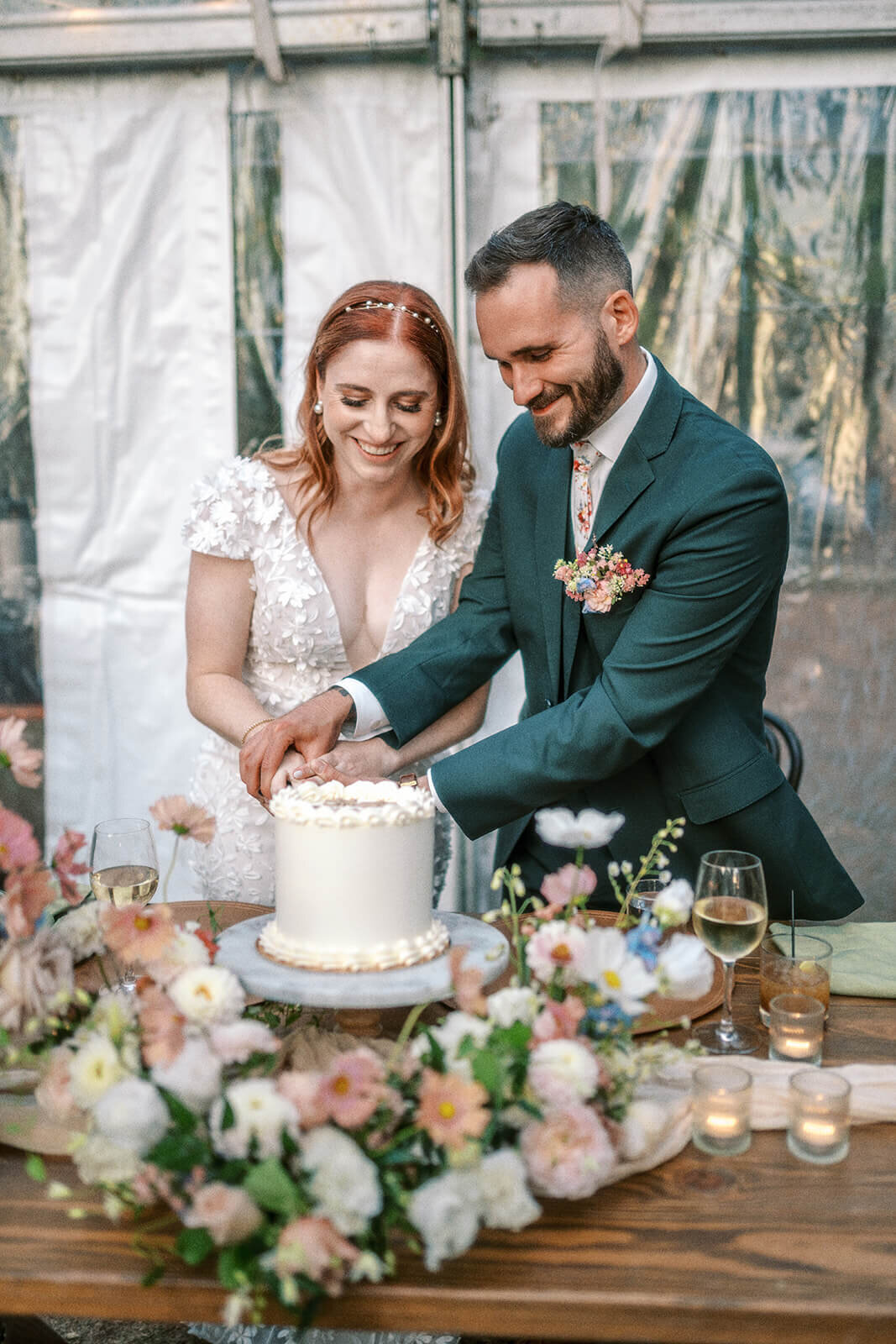 A bride and groom cutting a wedding cake at their Suttle Lake Lodge wedding.