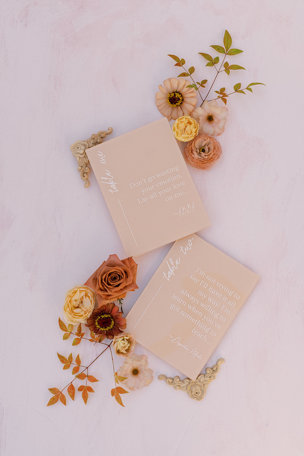 Blush vow books styled with romantic florals—sentimental wedding day details captured with elegance and heart.
