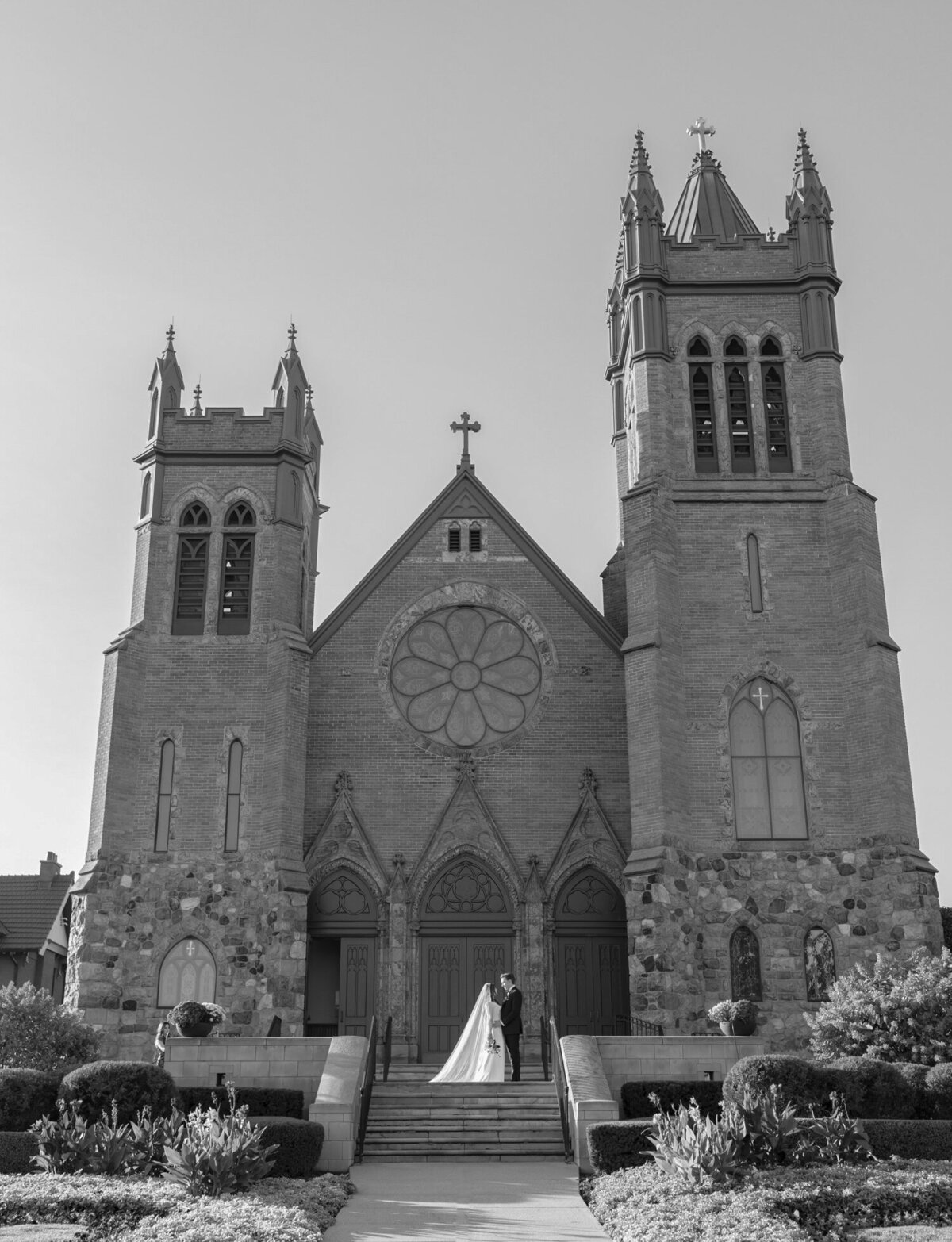 bride and groom outside their wedding venue, St. Paul on the Lake, an ornate cathedral in Detroit