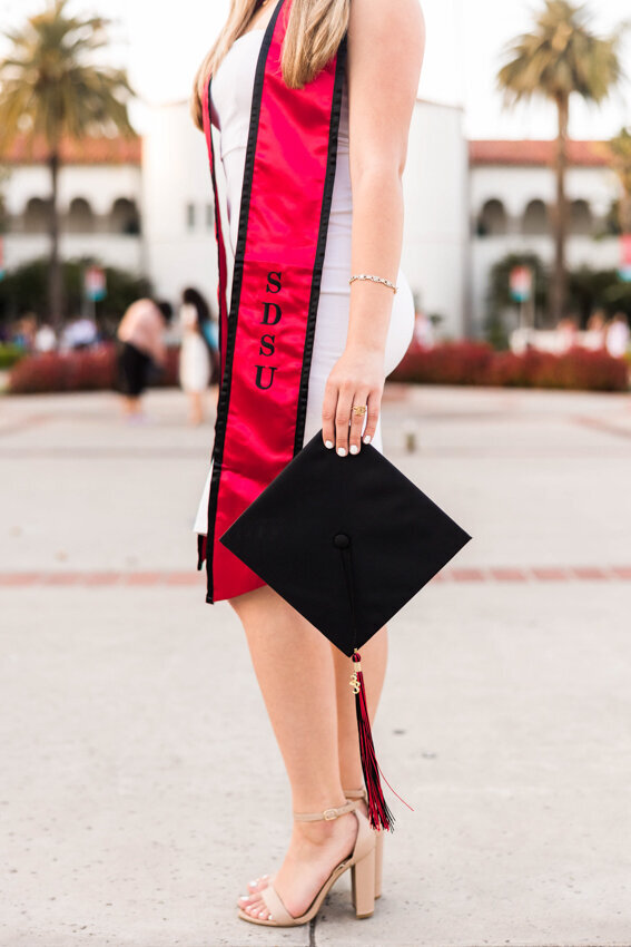 girl-holding-hat-with-sash-san-diego-state