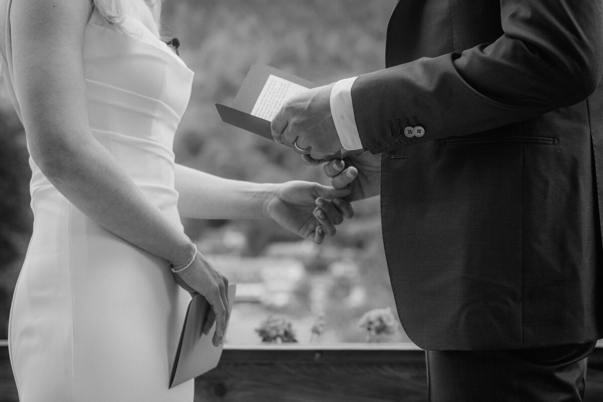 Black and white moment photography during wedding vows.