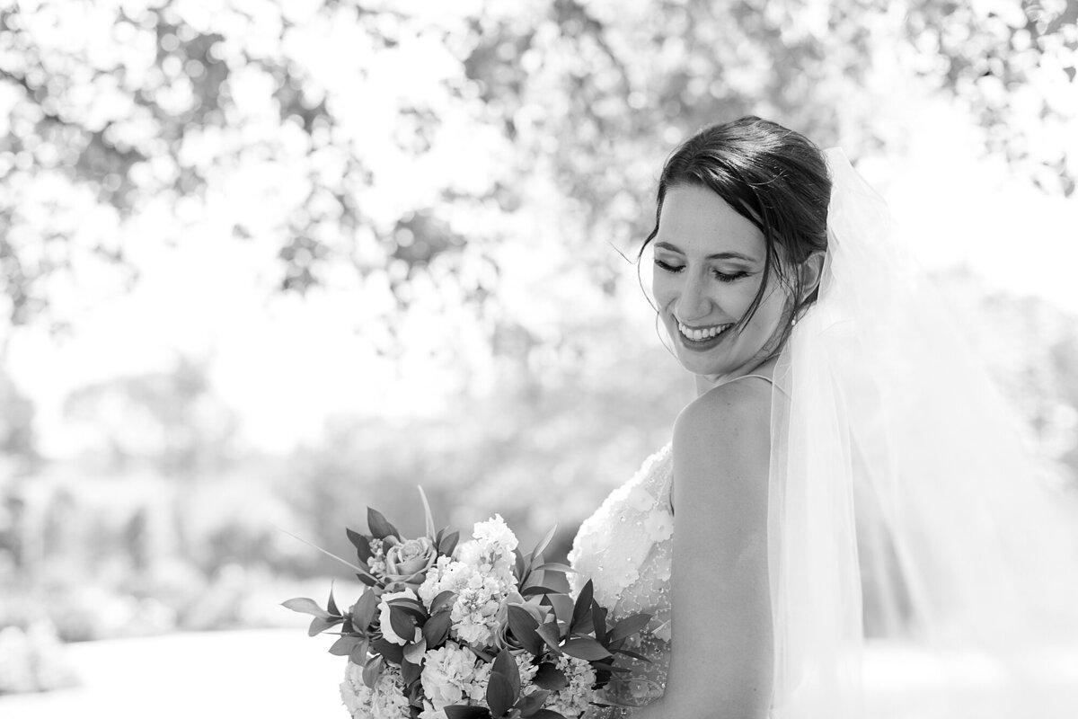 bride holding bouquet and laughing