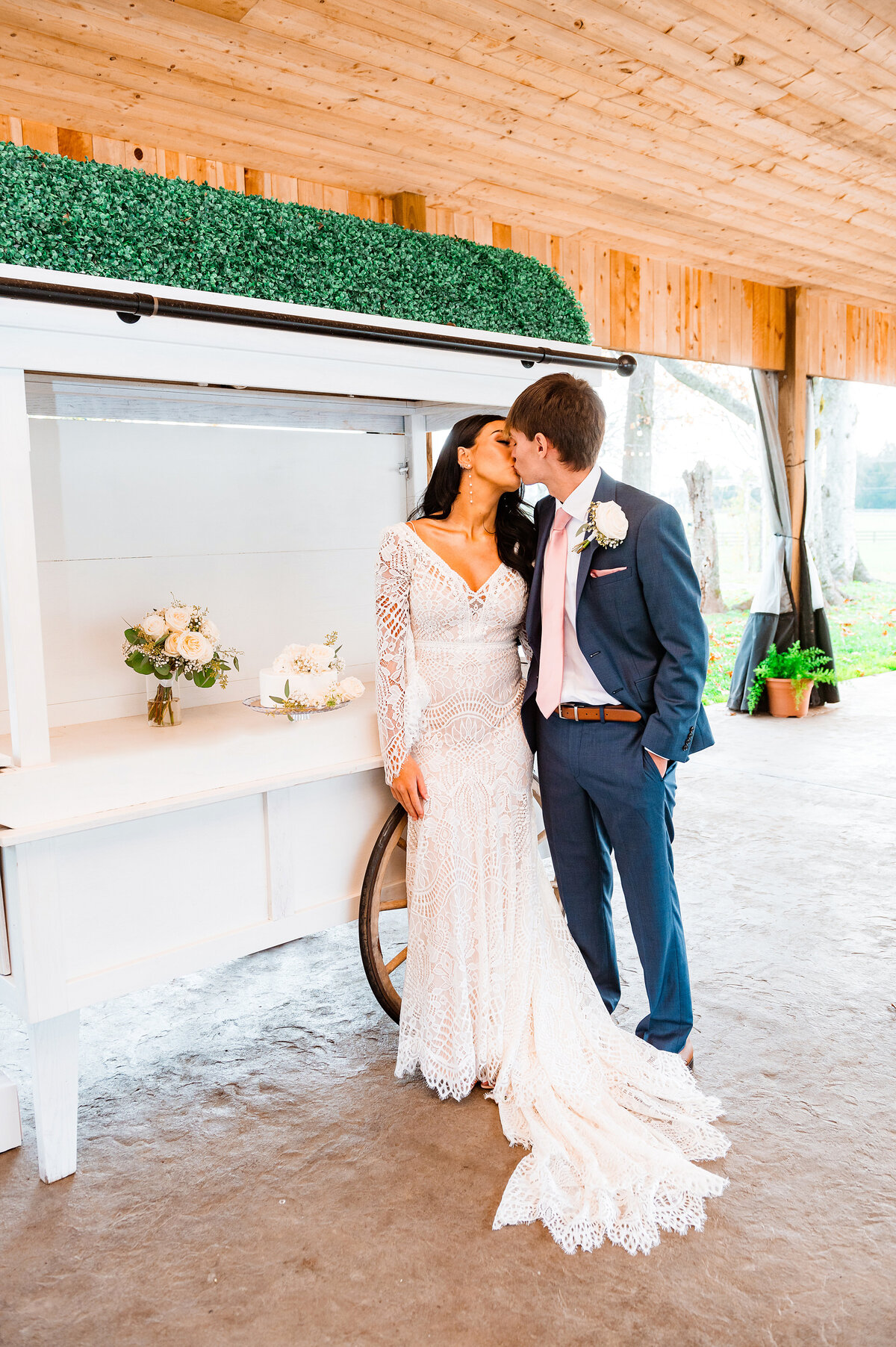 Bride and groom kissing before cutting their cake outside during their elopement