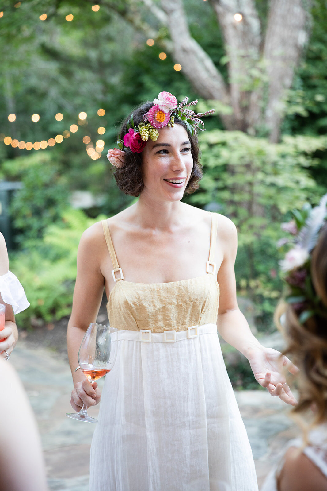 White linen welcome dinner with flower crown for every guest. Wildflower crown booth by Rosemary & Finch, RT Lodge and Nashville luxury wedding florist.